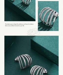 Detail shot of multi-row S925 sterling silver hoop earrings with clear gemstones