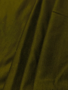 Close-up of olive green knitted cotton fabric texture with horizontal ribbed details