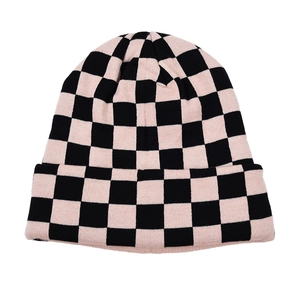 Detailed knit texture of pink and black checkerboard beanie with a folded cuff design