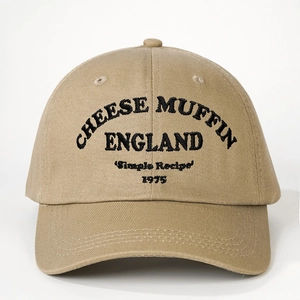 Close-up of Cheese Muffin embroidery detail on khaki cotton canvas baseball cap