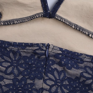 Detail of dark blue lace floral pattern and invisible zipper on the evening gown dress