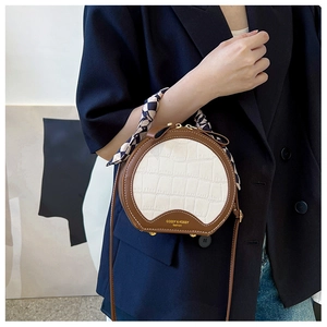 Chic round brown and white crocodile texture handbag with decorative checkered scarf wrap