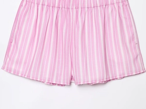 Detail of pink and white vertical striped cotton shorts with elastic waistband design