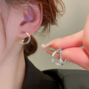 Silver crescent moon earrings with zircons shown worn and held for detail