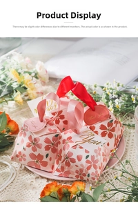 Detail of pink cherry blossom candy gift boxes with silk ribbons and thank you gift tags