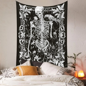 Close-up of gothic skeleton tapestry with crow and vines hanging on a white brick wall