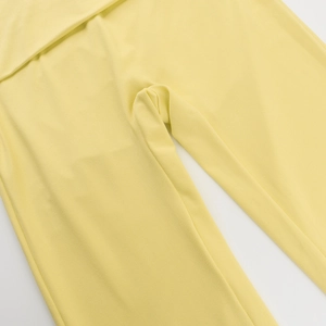 Detail view of yellow square-neck knit set showing crotch stitching and high-elastic fabric