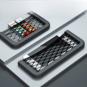 Detailed view of elastic mesh car storage pocket holding a smartphone and accessories