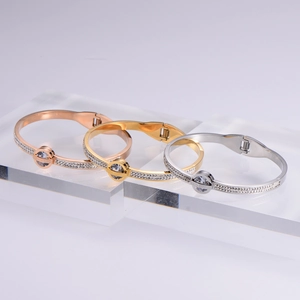 Three-piece stainless steel spring bracelets with Roman numerals and pavé crystal accents