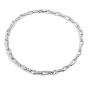 Detailed macro view of silver chain necklace with zircon-encrusted rectangular link accents