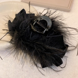 Elegant black feather hair claw clip with pleated velvet texture for a classic woman style