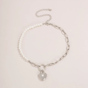 Asymmetric necklace with white pearls, silver chain links and a polished heart pendant