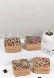 Macro shot of four cork jewelry boxes with colorful mandala and floral patterns on top