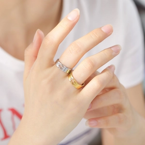 Unisex stainless steel spider cutout rings in gold and silver finish on hand