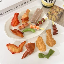Detailed view of realistic food-shaped hair clips including chicken wing and drumstick styles
