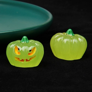 Close-up of green luminous 3D Halloween pumpkins with glowing Jack-o'-lantern face