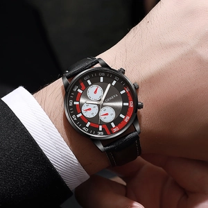 Close-up of Geneva men's watch featuring a black leather strap and red sunburst dial