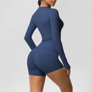 Detail view of the sleek gray-blue athletic set fabric texture and ergonomic side seams