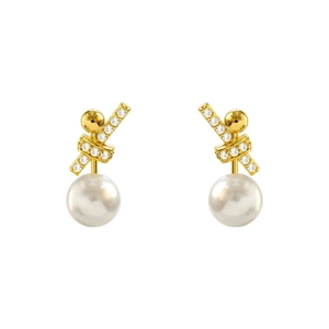 Detailed macro view of champagne gold twist earrings with micro-set diamonds and white pearl