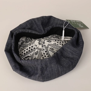 Women's deep blue denim beret hat with hemp texture and floral lining on beige background