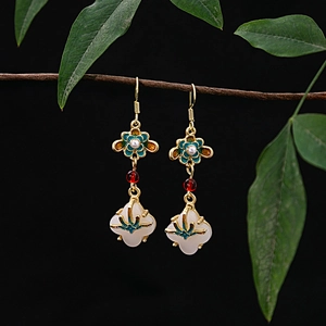 Detail of Chinese style earring with green enamel flower and white jade drop pendant