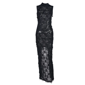 Macro shot of black sleeveless maxi dress featuring artistic ripped texture and lace hollow details
