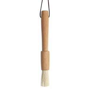 Minimalist Japanese beech wood BBQ brush with natural bristles and hanging rope on white backdrop