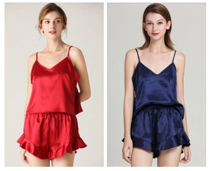 Detail of silk satin camisole pajama set with V-neck top and ruffle shorts in red and navy