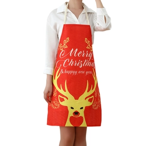 Red linen Christmas apron with reindeer print and Merry Christmas text on white background