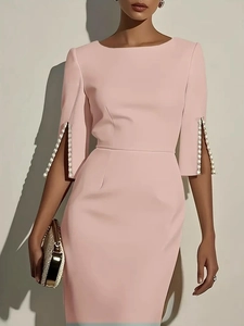 Detail of light pink fitted dress featuring elegant white pearl bead cuffs and side slit