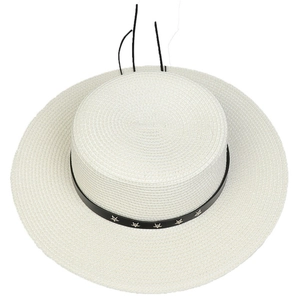 Top down view of a white wide brim straw sun hat with black leather star ribbon