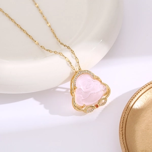Macro detail of Buddha pendant necklace with pink resin and gold zircon framing