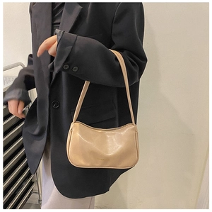 Detail of minimalist beige faux leather shoulder bag featuring 'FASHION & BAGS' text