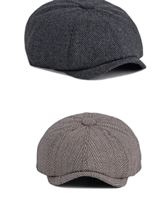Close-up of dark grey and light brown newsboy caps showing herringbone wool texture