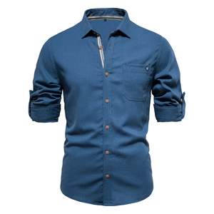 Detailed view of navy blue cotton shirt texture with contrasting wood-style buttons