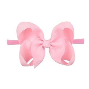Pink nylon baby headband featuring a large textured bubble flower bow for infants