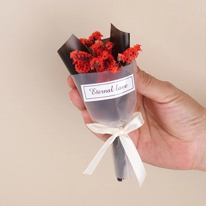 Close-up of a small bouquet of red dried flowers with a black wrap and Eternal love sticker