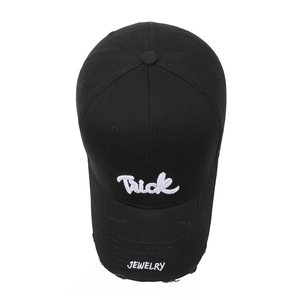Black distressed baseball cap with white Trick embroidery and frayed brim for street style