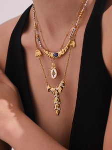 Close-up of layered necklace with blue kyanite and starburst enamel pendants