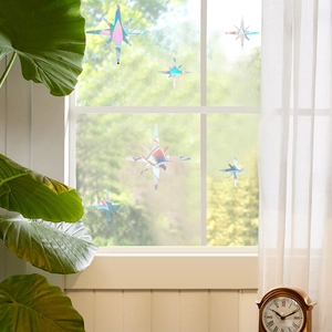 Rainbow prism static window film with star patterns reflecting colorful light on glass