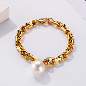 Detail of gold titanium steel curb chain bracelet with large white round pearl
