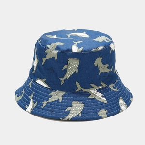 Close-up of reversible bucket hat with blue and grey shark prints on soft cotton fabric