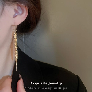 Elegant gold leaf tassel drop earrings for women with long fringe and high-quality plating