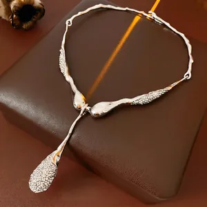 Silver Y-shaped rhinestone necklace with organic flowing lines on premium leather box