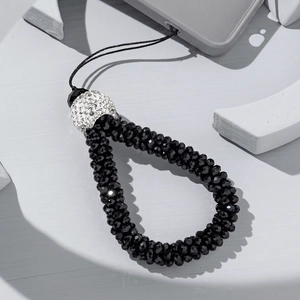 Detail of beaded phone strap with black faceted beads and sparkling rhinestone ball charm