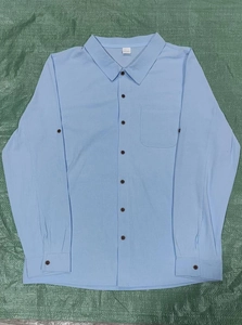 Detail view of cotton linen shirt collar and buttons with light blue fabric texture