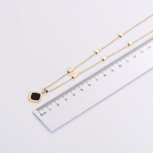 Measurement of golden necklace with square black pendant and Roman numerals scale