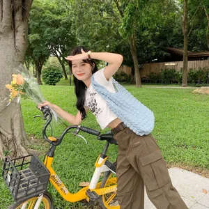 Light blue bubble puff shoulder bag paired with cargo pants in an outdoor park setting