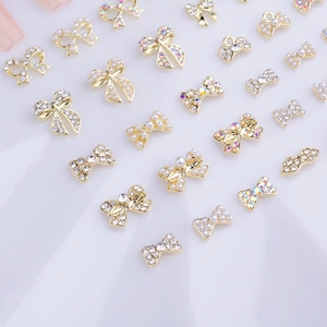 Japanese style 3D alloy bow nail art charms with crystals and pearls on white background