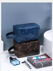 Detail of waterproof PU leather toiletry bags with vintage texture and sturdy side handles